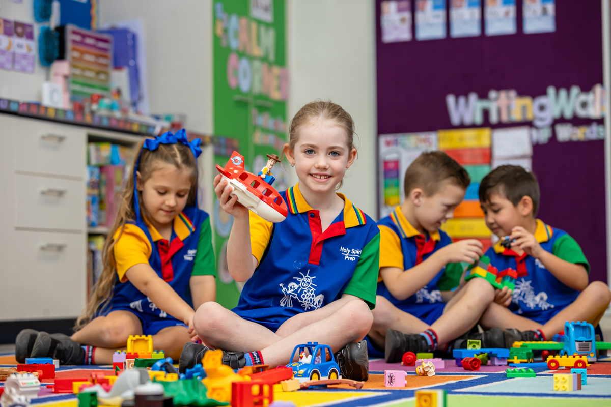 Children standing with sports equipment